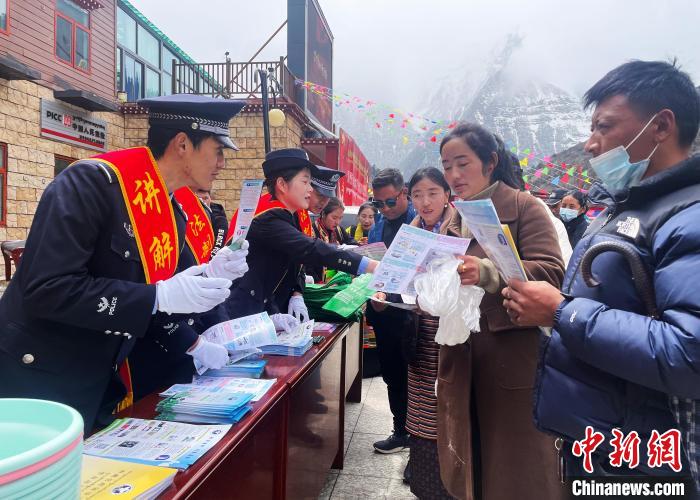 圖為山南玉麥邊境派出所民警為轄區(qū)群眾發(fā)放法律知識(shí)宣傳單?！＄婗?　攝